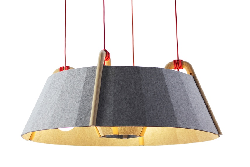 The faceted shape of the recycled polyester felt shade helps reduce ambient noise.
